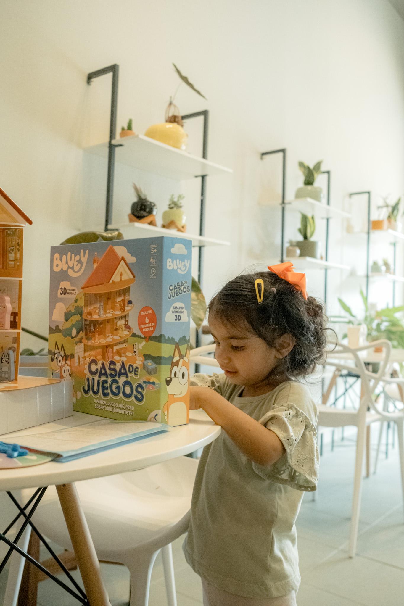Child playing with Bluey in the Alere kids' nook